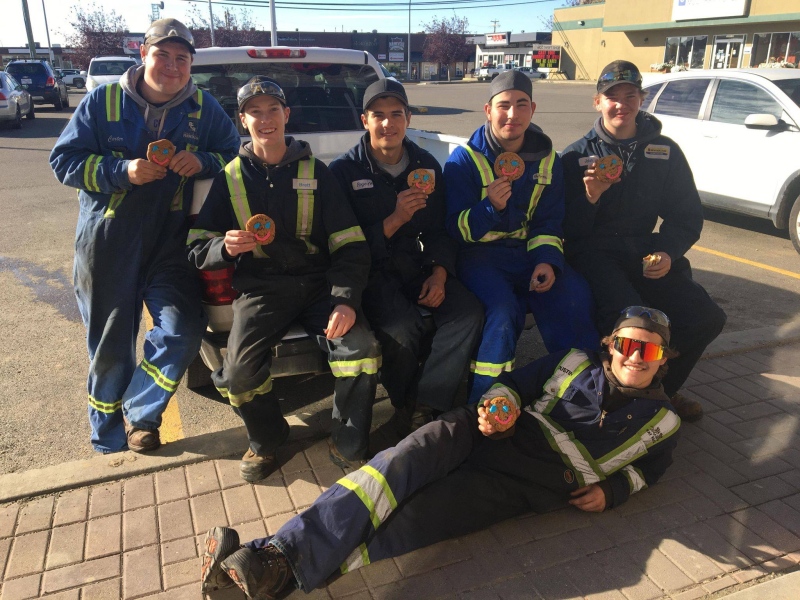 (Courtesy: Fort St. John Hospital Foundation)  Heavy Duty Mechanic Students from Northern Lights College Enjoying Their Smile Cookies.