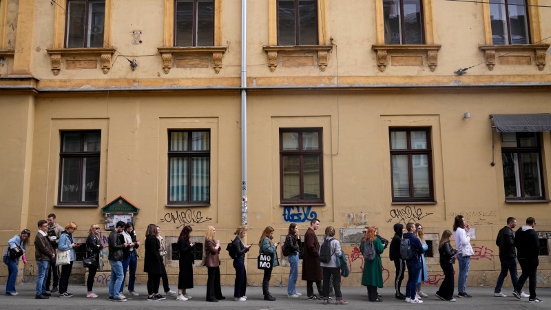 Voters wait near a polling station in Zagreb, Croatia, Wednesday, April 17, 2024. (AP Photo/Darko Bandic)