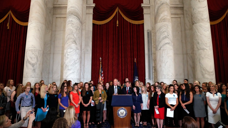 Sen. Jerry Moran, R-Kansas, centre left, and Sen. Richard Blumenthal, D-Conn., attend a news conference with dozens of women and girls who were sexually abused by Larry Nassar, a former doctor for Michigan State University athletics and USA Gymnastics, July 24, 2018, on Capitol Hill in Washington. (AP Photo/Jacquelyn Martin, File)