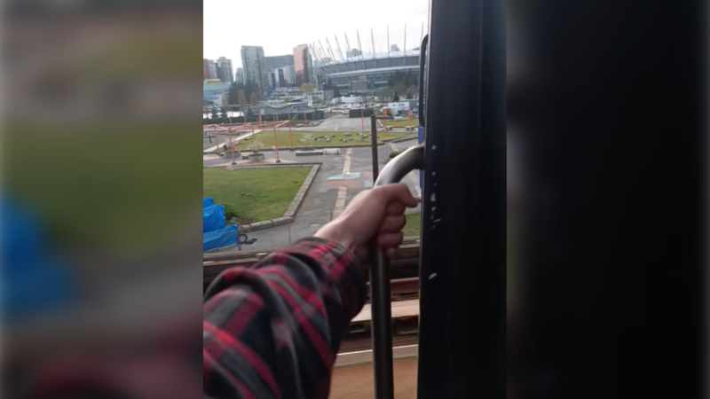 A social media daredevil rides on the outside of a SkyTrain heading towards downtown Vancouver. (Instagram) 