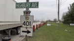 A transport truck prepares to turn onto Highbury Avenue from Centennial Drive in St. Thomas on April 17, 2024, in advance of a project to twin the roadway. (Sean Irvine/CTV News London) 