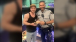  Kai Heinrich, Const. Fed Angulo and Milkshake are pictured at Purple Seahorse Pet Store in this photo handed out by the Kelowna RCMP. 