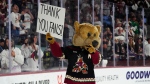 Arizona Coyotes mascot Howler acknowledges holds a sign after the team's NHL hockey game against the Edmonton Oilers on Wednesday, April 17, 2024, in Tempe, Ariz. The Coyotes won 5-2. (Ross D. Franklin / AP Photo)