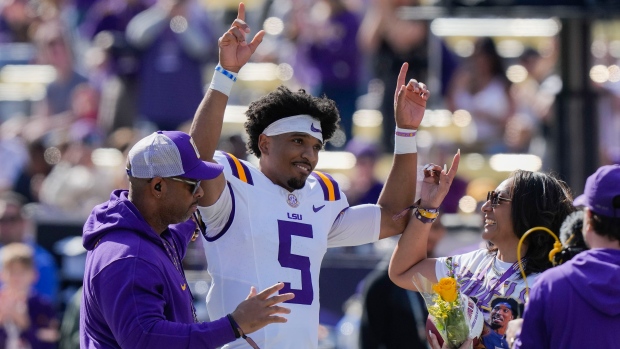 LSU quarterback Jayden Daniels (5) celebrates with his parents on senior day, for his final home game, before an NCAA college football game against Texas A&M in Baton Rouge, La., Saturday, Nov. 25, 2023. (AP Photo/Gerald Herbert, File)