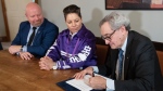 Hydro Quebec chief executive Michael Sabia, signs the joint ownership agreement for the Hertel-New York Transmission Line as Mohawk Grand Chief Kahsennenhawe Sky-Deer and Quebec Minister of First Nations Relations Ian Lafreniere, left, look on during a news conference, Thursday, April 18, 2024 in Kahnawake, Que. (Ryan Remiorz, The Canadian Press)