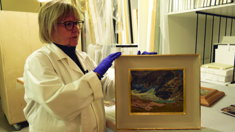 Anne Ewen, the director and chief curator at the Whyte Museum, shows of a James Edward Hervey MacDonald painting. (CTV News) 