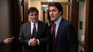 RCMP keep an eye on Prime Minister Justin Trudeau as he speaks briefly with media alongside Minister of Public Safety, Democratic Institutions and Intergovernmental Affairs Dominic LeBlanc before entering the House of Commons, in Ottawa, Wednesday, Nov. 22, 2023. THE CANADIAN PRESS/Adrian Wyld