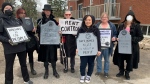 A group of people attend a mock funeral organized by ACORN mourning the death of 'affordable housing' in Kitchener on April 18, 2024. (Jeff Pickel/CTV News)