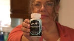 Carla Anne Ferguson is holding a bottle of Umary Hyaluronic Acid Dietary Supplement pills on April 16, 2024. (Danton Unger/CTV News Winnipeg)