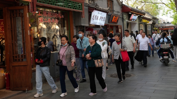 Visitors pass through at the Nanluoguxiang, the capital city's popular tourist spot in Beijing, China. (Tatan Syuflana/AP Photo)