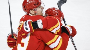The Calgary Flames' Adam Klapka celebrates his first NHL goal with teammate MacKenzie Weegar in Calgary on April 18, 2024. The Flames beat the San Jose Sharks 5-1. THE CANADIAN PRESS/Jeff McIntosh