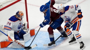 Colorado Avalanche left wing Zach Parise, center, puts a shot on Edmonton Oilers goaltender Stuart Skinner, left, after driving past defenseman Troy Stecher during the first period of an NHL hockey game Thursday, April 18, 2024, in Denver. (David Zalubowski / The Associated Press) 
