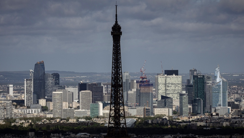 The Eiffel Tower is seen, with the business district La Defense in background, Monday, April 15, 2024 in Paris. (AP Photo/Aurelien Morissard)
