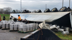 Dozens of kegs of beer spilled out of a tractor-trailer after a single-vehicle crash on Hwy. 401 in Brockville.  (Ontario Provincial Police/X)
