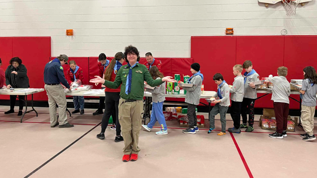 Nathan Brennan in front of the assembly line from Cub Pack, Scout Troop and Venture Company. (Courtesy: Melinda Brennan)