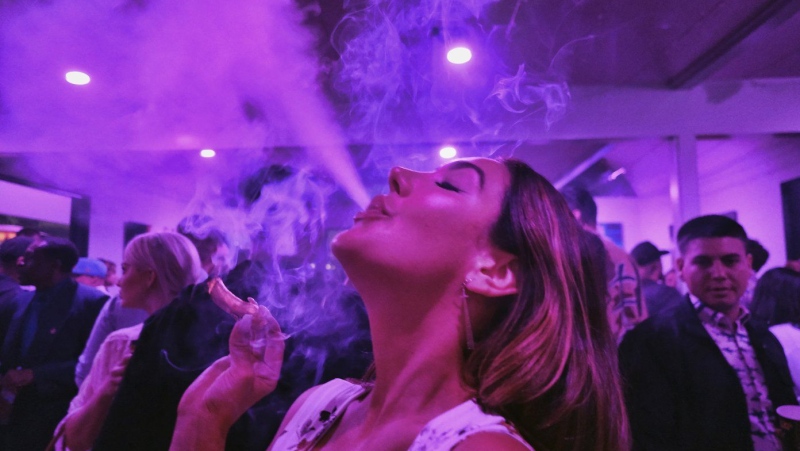 A guest takes a puff from a marijuana cigarette at the Sensi Magazine party celebrating the 420 holiday in the Bel Air section of Los Angeles, April 20, 2019. (Richard Vogel, / AP Photo, File)