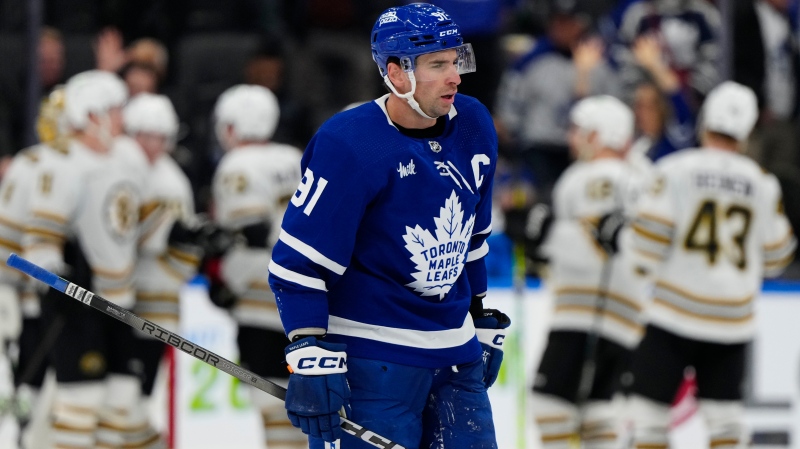 Toronto Maple Leafs centre John Tavares (91) skates off the ice as Boston Bruins players celebrate in the background after NHL hockey action in Toronto on Monday, March 4, 2024. THE CANADIAN PRESS/Frank Gunn