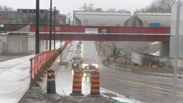 A parade of vehicles follow a construction truck as they become the first to use the newly-opened Adelaide Street North underpass on April 19, 2024. (Gerry Dewan/CTV News London) 