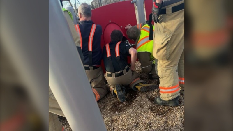 Fire crews in Lorette, Man. working to help free an eight-year-old from a playground structure on April 14, 2024. (Keanna Deslauriers)