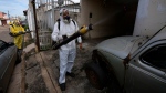Public health workers spray insecticide during a fumigation campaign in the Ceilandia neighbourhood of Brasilia, Brazil, Friday, Feb. 16, 2024. (Eraldo Peres / AP via CNN Newsource)