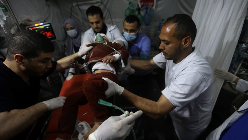 Palestinians carry the wounded in the Israeli bombardment of the Gaza Strip, to the Kuwaiti Hospital in Rafah refugee camp, southern Gaza Strip, Saturday, April 20, 2024. (AP Photo/Ismael Abu Dayyah)