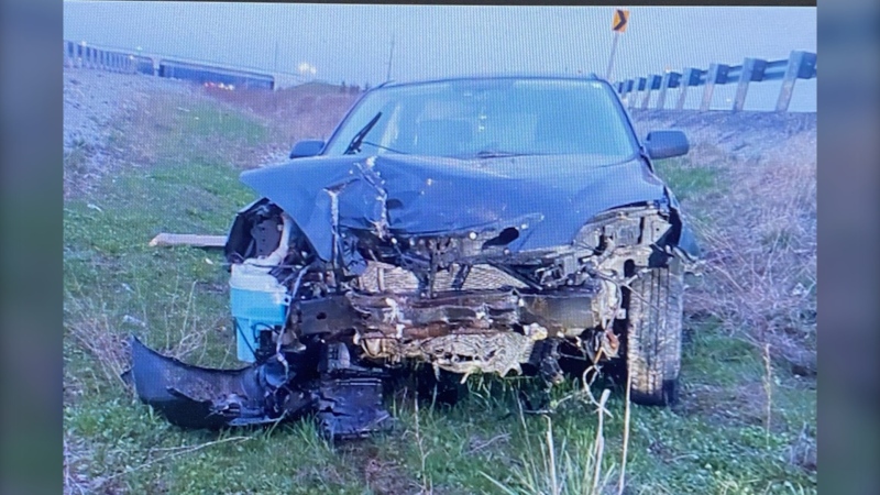 A vehicle that crashed through a guardrail on Highway 400 near Innisfil early in the morning of April 20, 2024 (OPP/X).