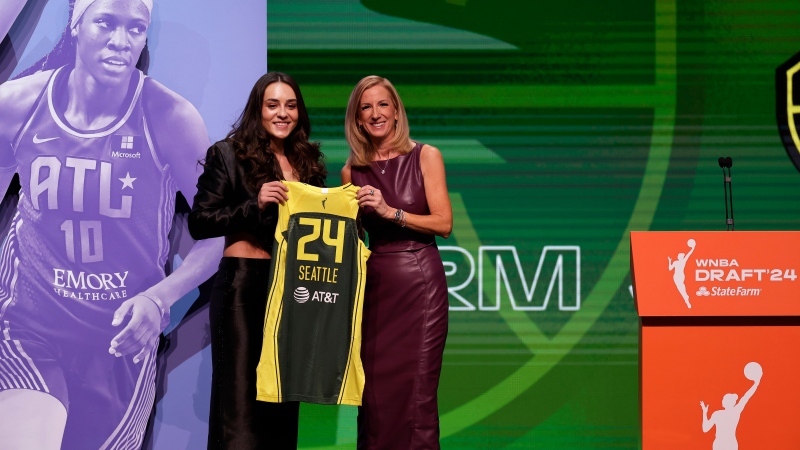 Nika Muhl, left, poses for a photo with WNBA commissioner Cathy Engelbert, right, after being selected 14th overall by the Seattle Storm on April 15, 2024, in New York. (Adam Hunger)