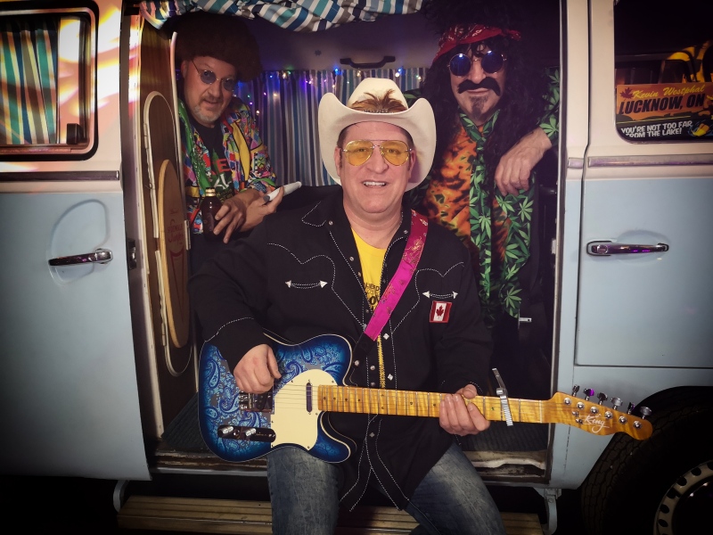 Musician Kevin Westphal sits in a van, holding a blue guitar. (Submitted: Danny Bailey)