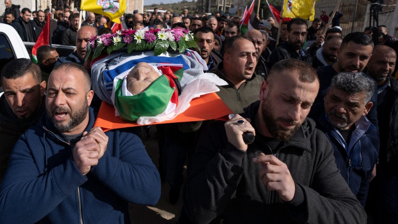 FILE - Mourners carry the body of Omar Assad, during his funeral in the West Bank village of Jiljiliya, north of Ramallah, Thursday, Jan. 13, 2022. (AP Photo/Nasser Nasser, File)