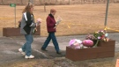 Friends of the Hannah family visit the murder scene on Sunday, March 14, 2010 to place flowers and notes of sympathy on the ground.