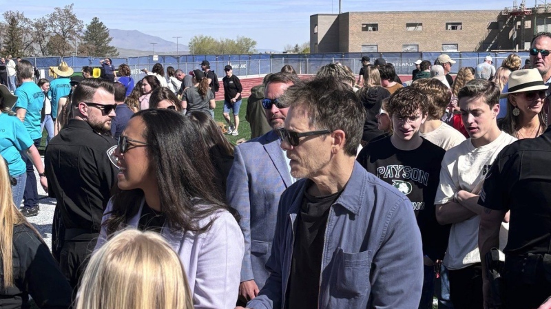 Kevin Bacon, centre, helps fill care packages for his charity while visiting the Utah high school where 'Footloose' was filmed. (Jesse Sorenson via AP)