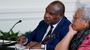 Papua New Guinean Prime Minister James Marape, left, listens during a meeting with Pacific Islands Forum leaders during the U.S.-Pacific Islands Forum Summit in the East Room of the White House, Monday, Sept. 25, 2023, in Washington. (AP Photo/Evan Vucci)