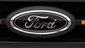 The company logo shines off the grille of an unsold 2024 F150 pickup truck outside a Ford dealership Sunday, Jan. 21, 2024, in Broomfield, Colo. (AP Photo/David Zalubowski)