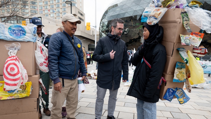 Minister of Environment and Climate Change of Canada Steven Guilbeault, centre, speaks with Indonesian climate activist Aeshnina Azzahra, right, following a 'March to End the Plastic Era' rally on Parliament Hill in Ottawa, on Sunday, April 21, 2024. THE CANADIAN PRESS/Spencer Colby