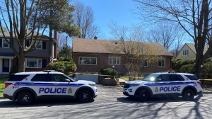 Two Ottawa police cruisers remain parked outside a Birch Avenue home following Friday's homicide at the home in Manor Park. (Katie Griffin/CTV News Ottawa)