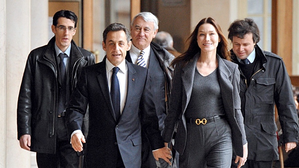 French President Nicolas Sarkozy and his wife Carla Bruni-Sarkozy, foreground, arrive at a polling station before voting for the first round of the regional elections in Paris, Sunday, March 14, 2010. (AP / Eric Feferberg, Pool)