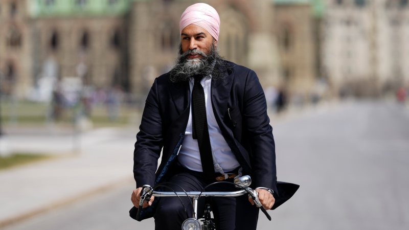 NDP Leader Jagmeet Singh arrives to Parliament Hill on his bicycle in Ottawa on Tuesday, April 9, 2024. THE CANADIAN PRESS/Sean Kilpatrick