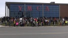 Almost 100 people dedicated to saving the Sault Ste. Marie YMCA from closure gathered in front of the facility in a showing of support on April 22, 2024. (Mike McDonald/CTV News Northern Ontario)