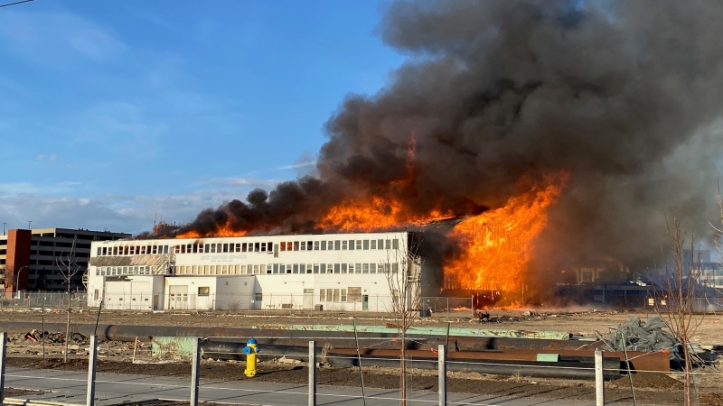 An old airport hangar on the former municipal airport grounds in central Edmonton next to the NAIT main campus burns on April 22, 2024. (Darcy Seaton/CTV News Edmonton)