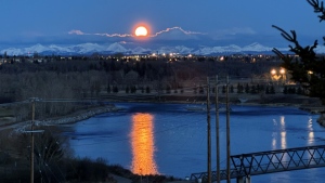 Now here is an excuse to get up early. Susan L. titles this photo, 'Morning Moon Over the Bow River'.