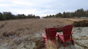 Red Muskoka chairs give hikers a break to enjoy the views of the marshland on the Thessalon Coastal Trail. April 20, 2024 (Town of Thessalon)
