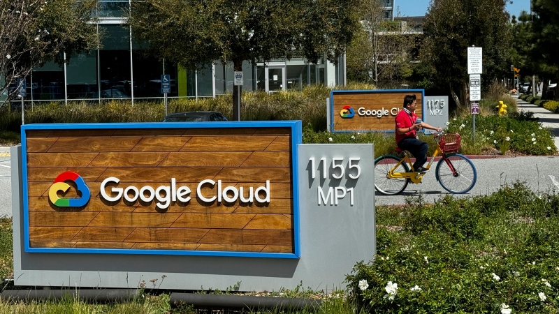 A person rides past the Google sign outside the Google offices in Sunnyvale, Calif., on Thursday, April 18, 2024. (AP Photo/Terry Chea)