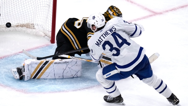 Toronto Maple Leafs centre Auston Matthews (34) beats Boston Bruins goaltender Linus Ullmark, back, for a goal during the third period of Game 2 of an NHL hockey Stanley Cup first-round playoff series, Monday, April 22, 2024, in Boston. (AP Photo/Charles Krupa)
