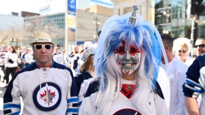 Winnipeg Jets fans arrive for a street party outside the arena prior to Game 1 of the NHL hockey Stanley Cup first-round playoff series against the Colorado Avalanche in Winnipeg, Sunday April 21, 2024. THE CANADIAN PRESS/Fred Greenslade