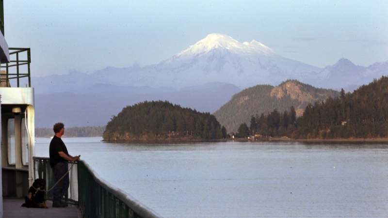 A Washington state ferry passes through a channel in the San Juan Islands and in view of Mount Baker Thursday, March 26, 2015, near Friday Harbor, Washington state. THE CANADIAN PRESS/AP-Elaine Thompson