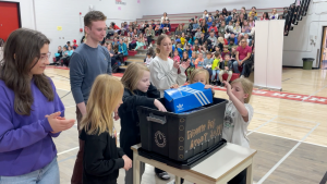Grade 3 students from Sundance, Janet Johnstone, Sam Livingston and Chinook Park schools place items into a time capsule at Dr E.P. Scarlett High School that they'll open in Grade 10. It's part of the 50th anniversary celebration of the CBE's French Immersion program. (CTV News) 