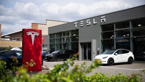 Cars are parked at a Tesla dealership in Berlin Tuesday, April 23, 2024. (Sebastian Christoph Gollnow/dpa via AP)