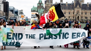People take part in a 'March to End the Plastic Era' rally on Parliament Hill in Ottawa, on Sunday, April 21, 2024. The fourth session of the Intergovernmental Negotiating Committee (INC) is set to take place in the nation's capital as delegates from 176 countries work to negotiate a treaty to eliminate plastic waste in less than 20 years. THE CANADIAN PRESS/Spencer Colby