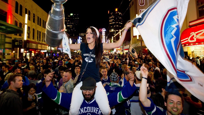 People celebrate on Granville Street in downtown Vancouver after the Canucks advanced to the NHL's Stanley Cup Final on Tuesday, May 24, 2011. (THE CANADIAN PRESS/Darryl Dyck)
