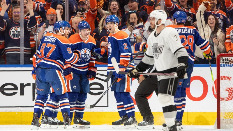 Los Angeles Kings' Matt Roy (3) skates past as Edmonton Oilers' Connor McDavid (97), Zach Hyman (18), Evan Bouchard (2) and Leon Draisaitl (29) celebrate a goal during third period of Game 1 first round NHL Stanley Cup playoff action in Edmonton on April 22, 2024. (Jason Franson/The Canadian Press)